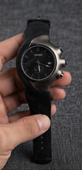 A Zeeno Place modern sports watch featuring a bold black Arabic numeral dial, comfortable silicone strap, and unique ergonomic curved case.