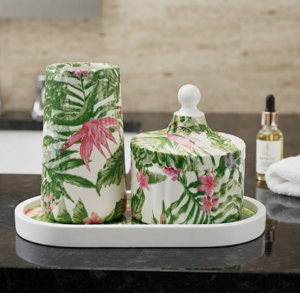 A Zeeno Place tropical botanical bathroom accessory set featuring a green palm leaf pattern, lidded container, and white display tray.