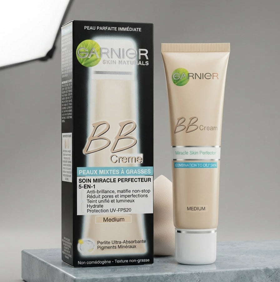 Garnier Skin Naturals BB cream tube and its packaging box in shade Medium displayed with a makeup sponge on a grey marble block