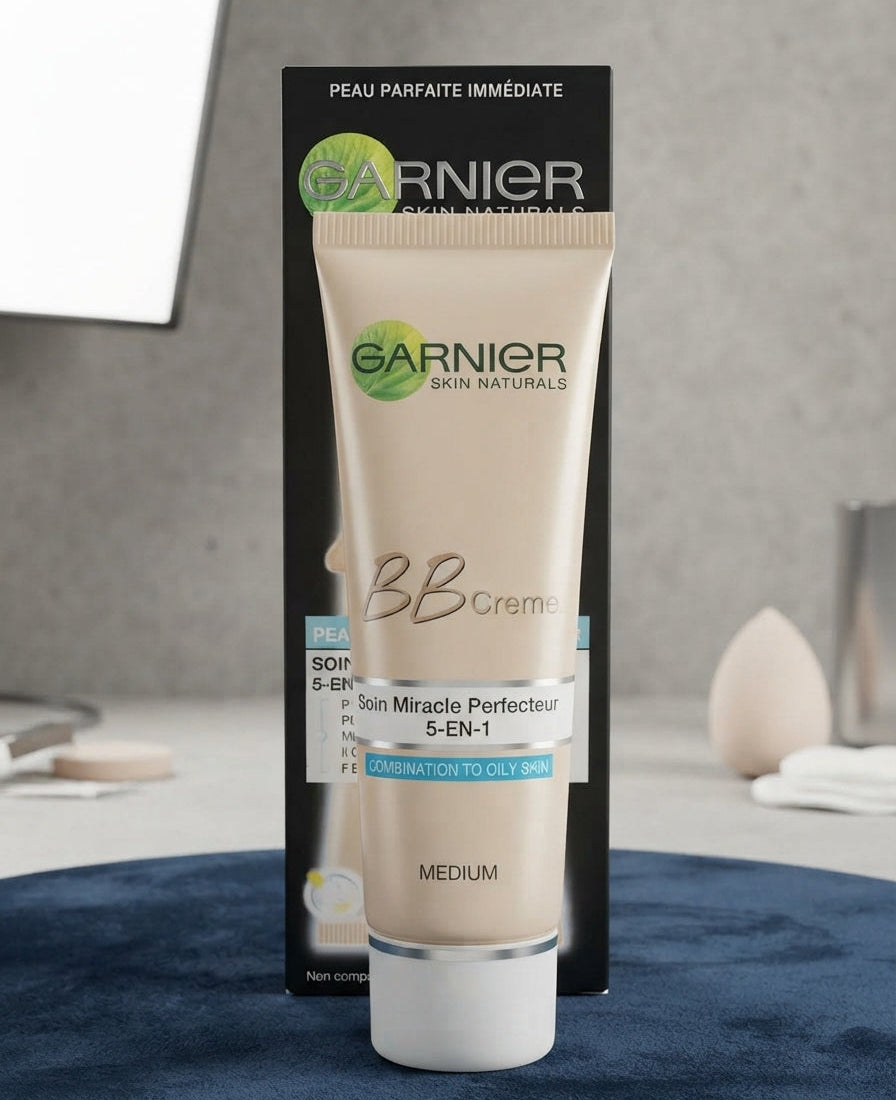 Garnier BB cream tube standing upright in front of its packaging box on a surface