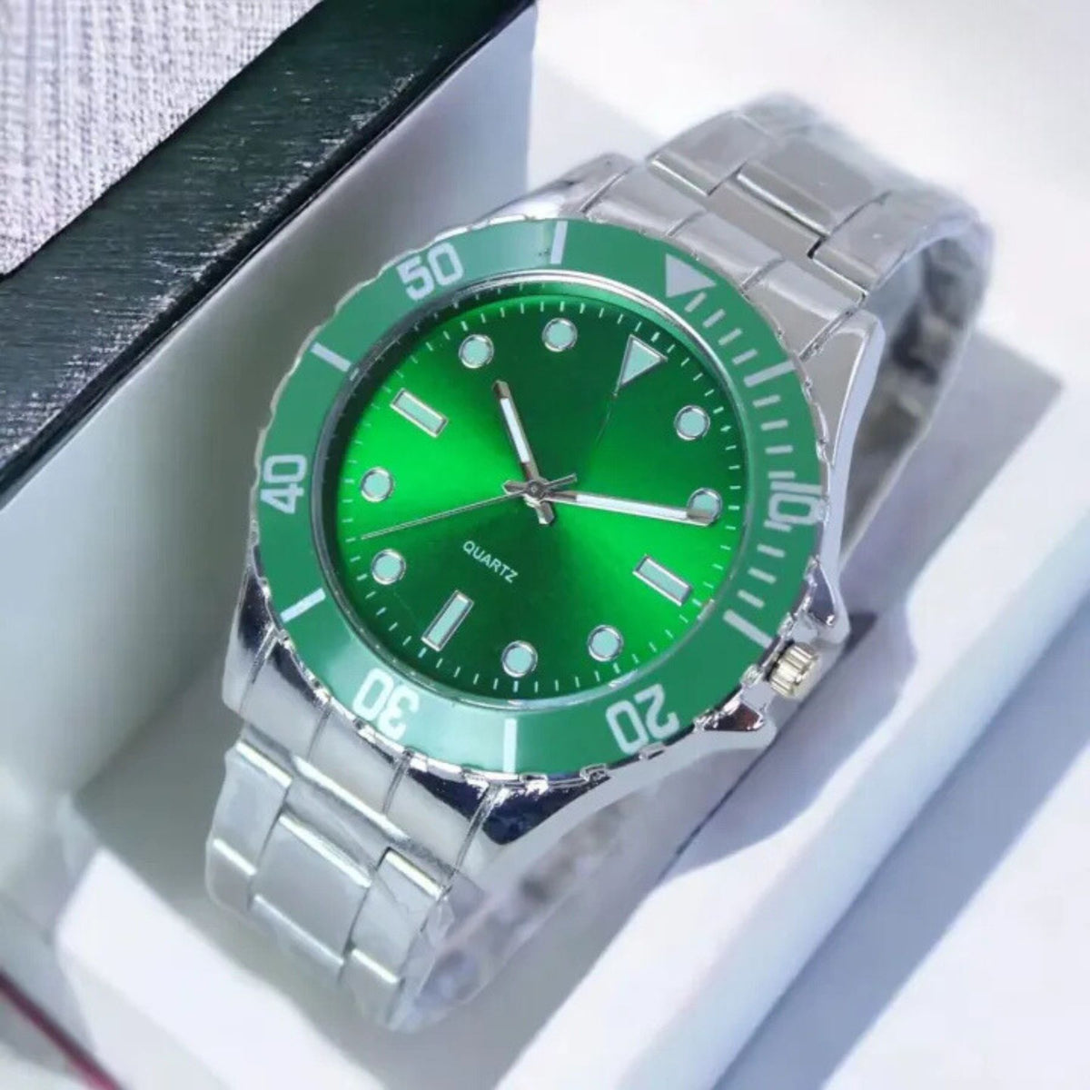 Stainless steel wristwatch with a vibrant green dial and matching bezel