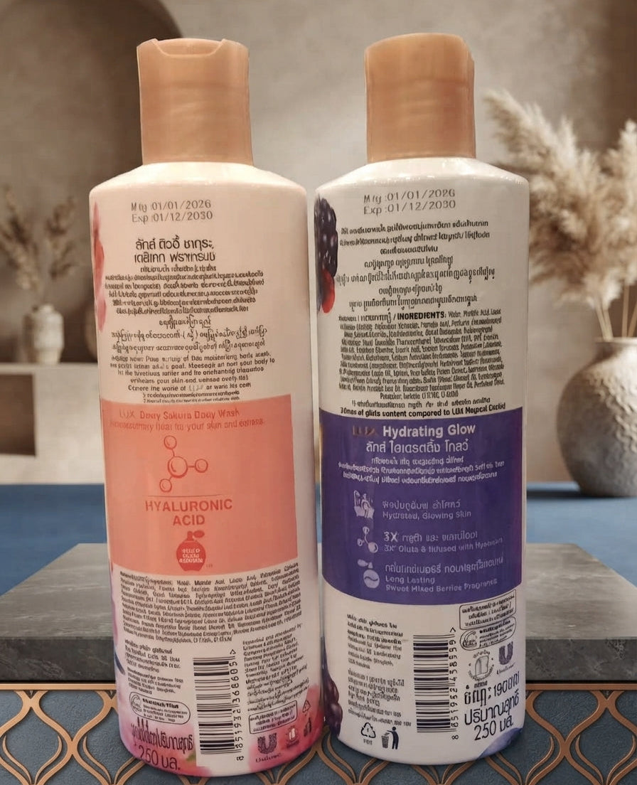 Back view of LUX Dewy Sakura and Sweet Mixed Berries body wash bottles showing ingredients, barcode, and Hyaluronic Acid information