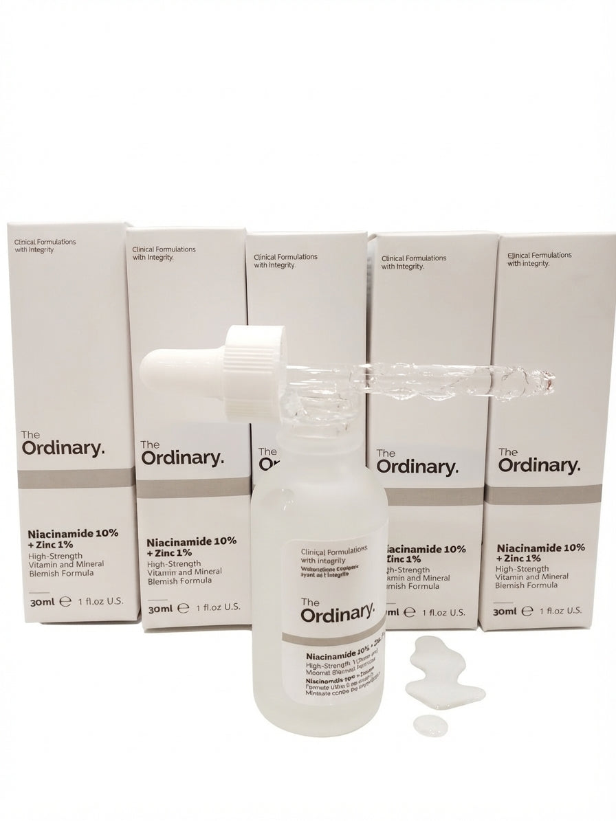The Ordinary Niacinamide 10% serum bottle standing in front of multiple product packaging boxes