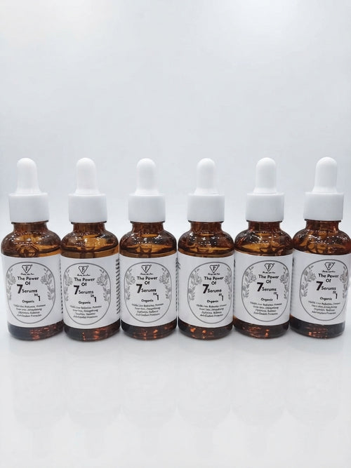 Multiple amber glass bottles of Beauty with Care The Power of 7 Serums in 1 lined up together