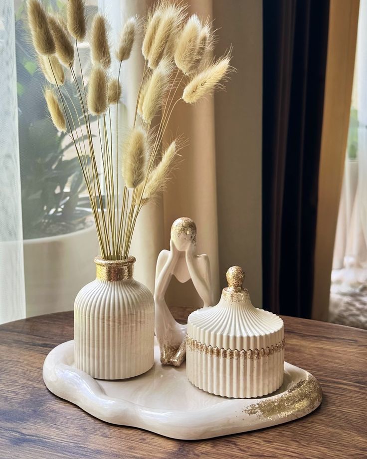 Aesthetic cream ribbed table decor set with gold trim, featuring bunny tail grass vase, thinker statue, lidded jar, and irregular tray by Zeeno Place