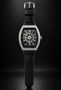 Luxury Franck Muller style men watch with black dial, crystal diamond bezel, and black leather-style strap against a dark background.